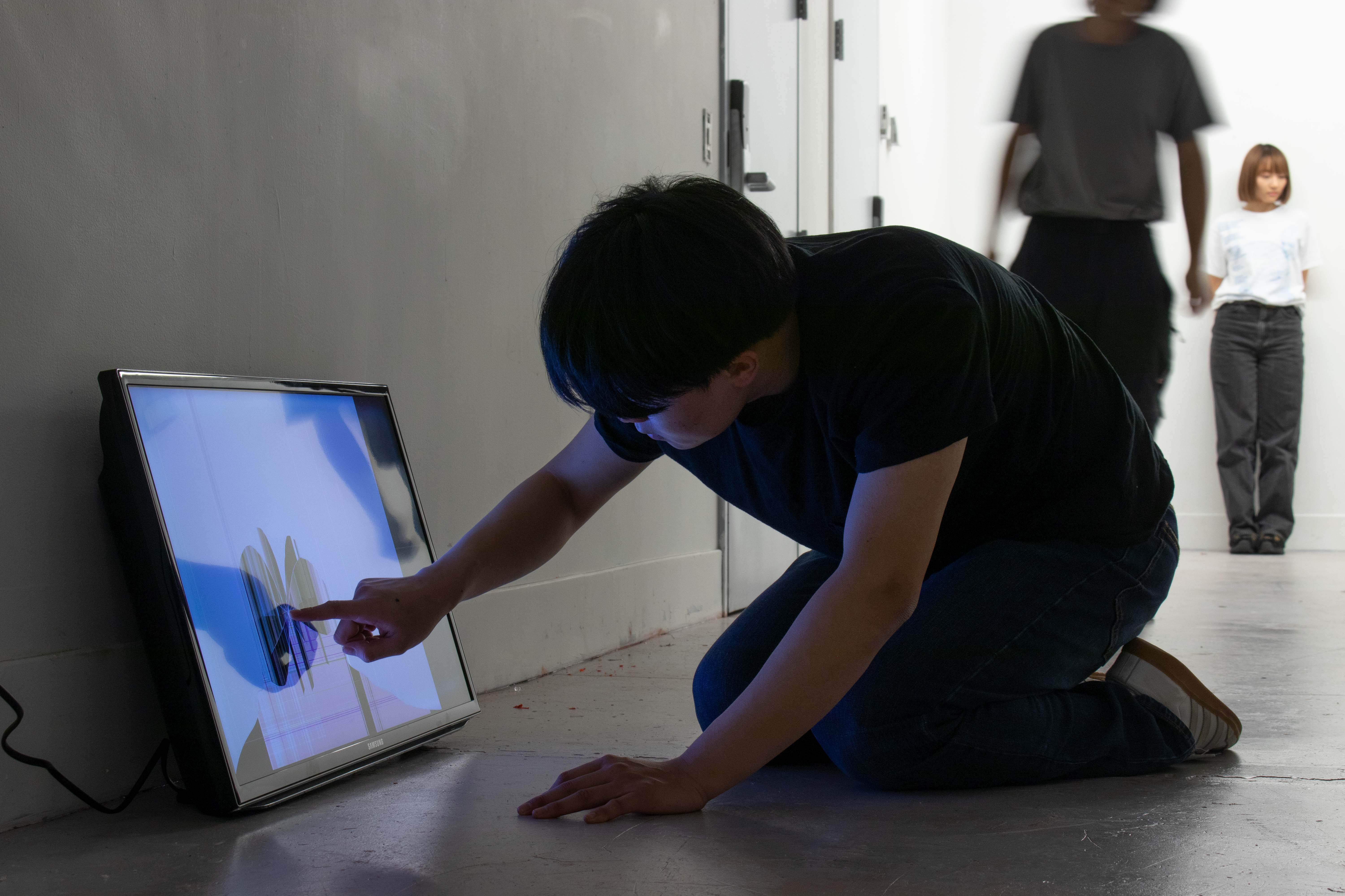a young man touching a broken screen