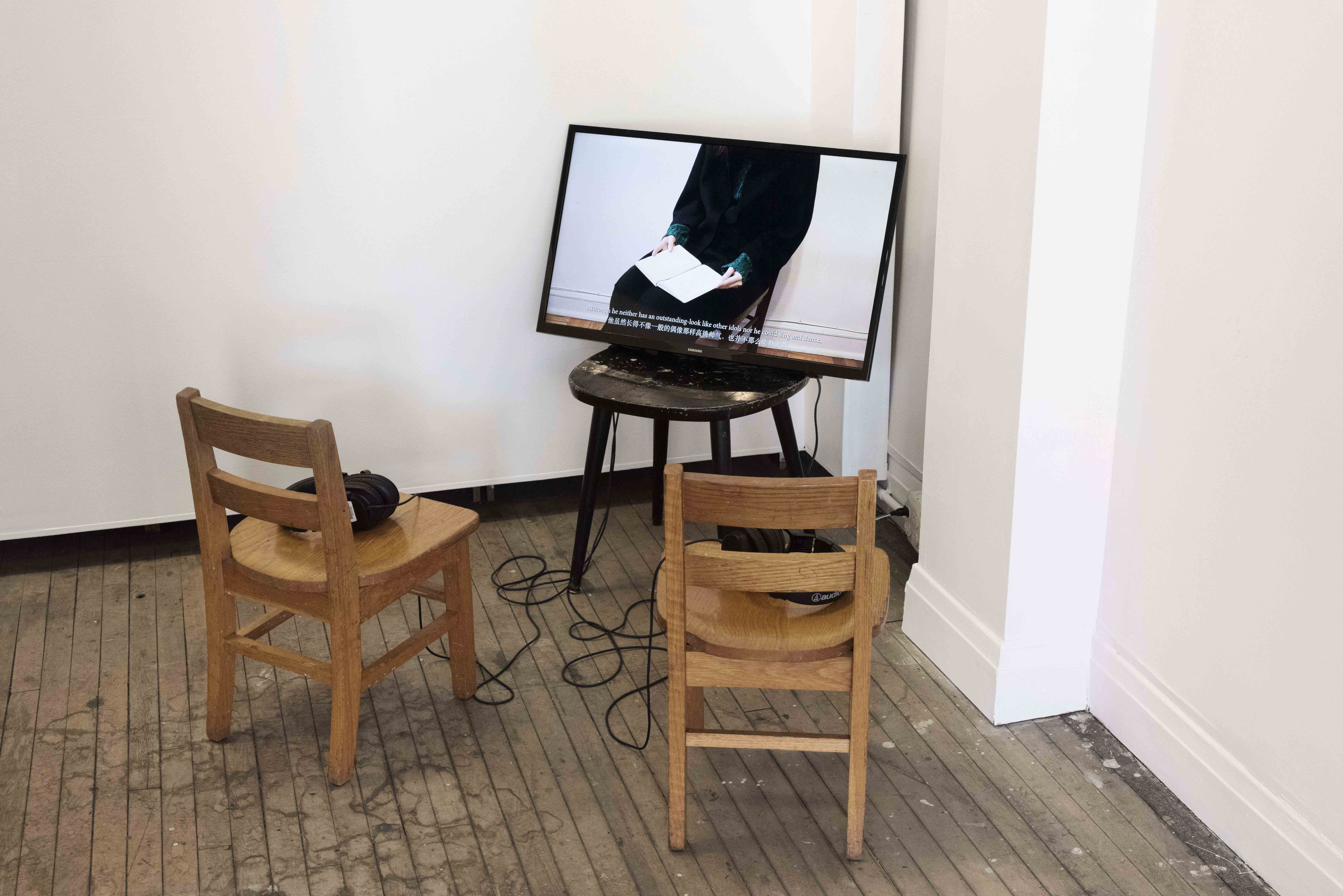 a video on a chair with chairs for the audience